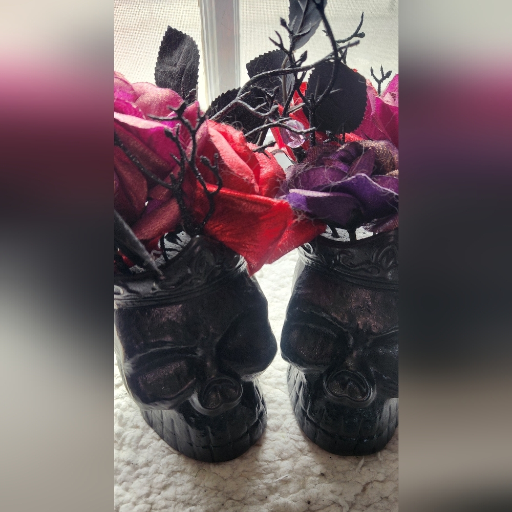 Black Skull Vases with Red and Purple Flowers